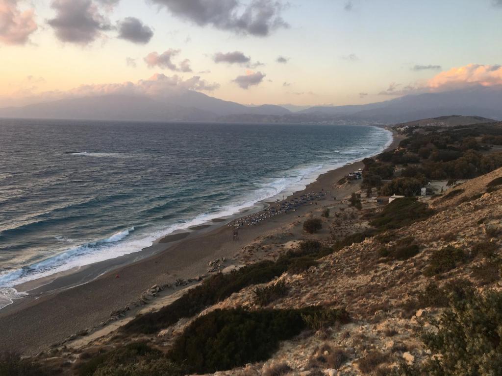 a view of a beach with the ocean at Irene Komos in Pitsidia