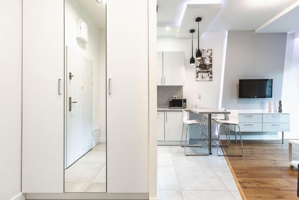 Televízia a/alebo spoločenská miestnosť v ubytovaní Perfect Apartament