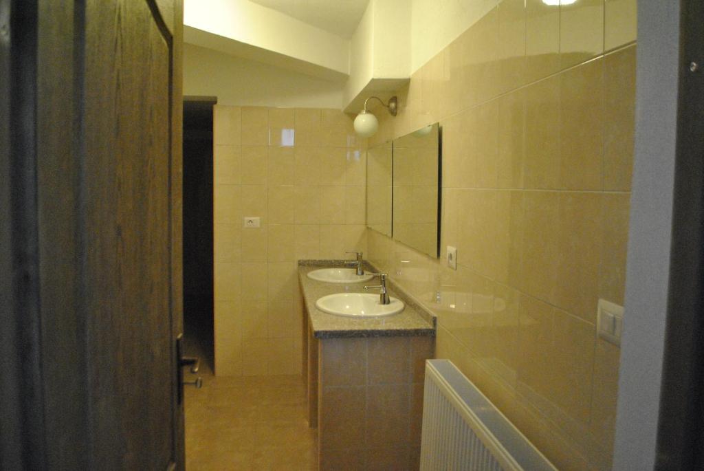 a bathroom with two sinks and a mirror at Activ Parc in Negreşti