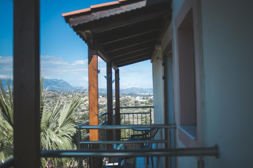 a balcony with a view of a city at Irene Komos in Pitsidia