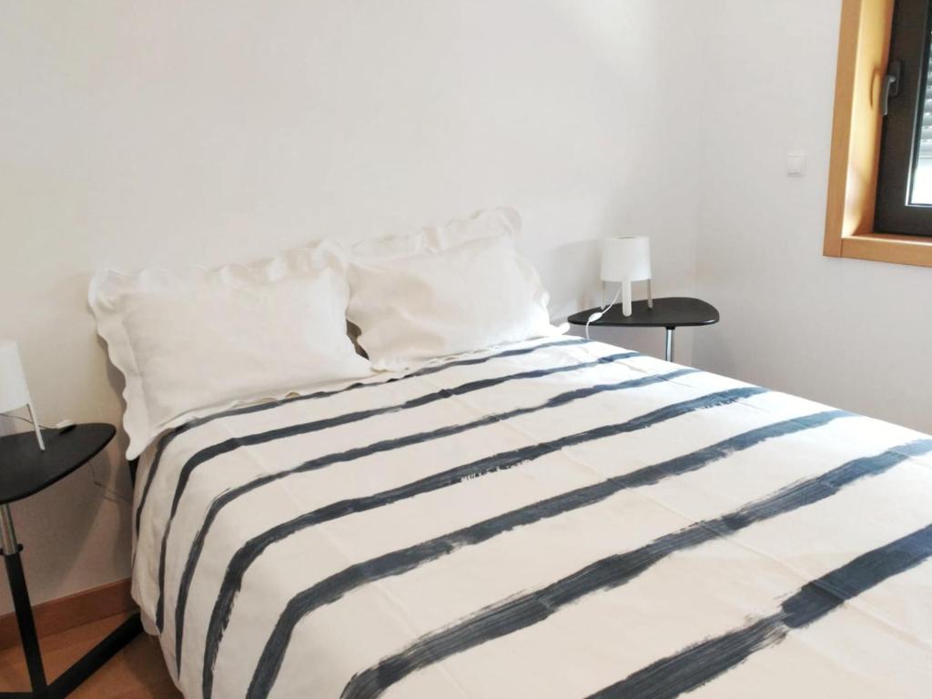 リスボンにあるApartamento Realの黒と白のストライプ毛布付きベッド