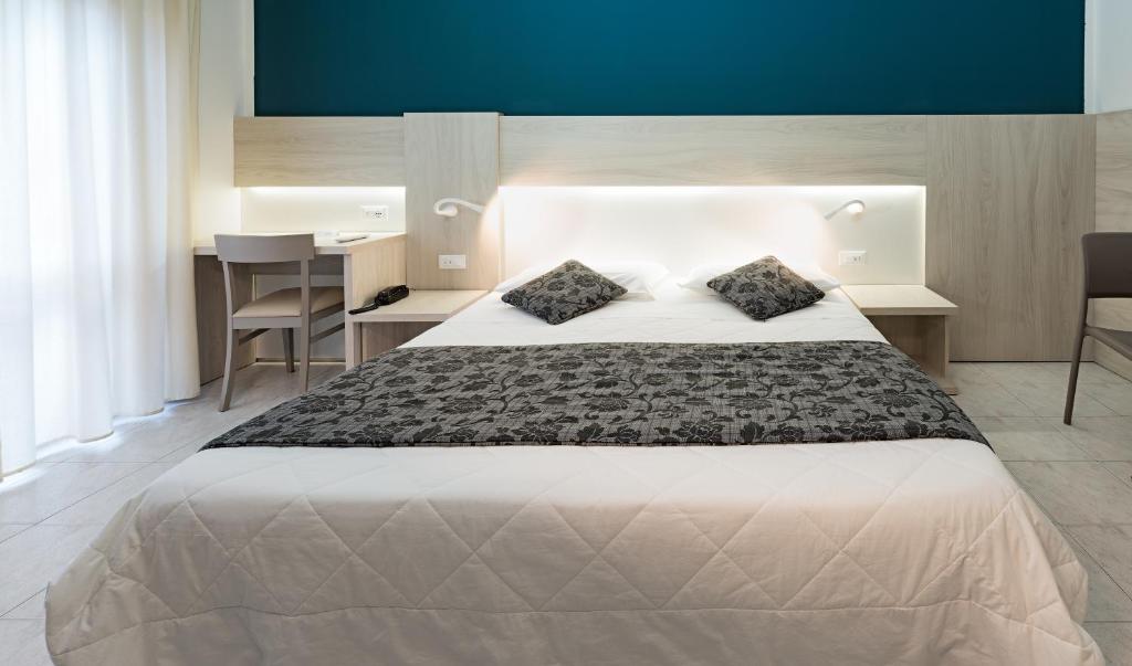 Posteľ alebo postele v izbe v ubytovaní Hotel il Delfino