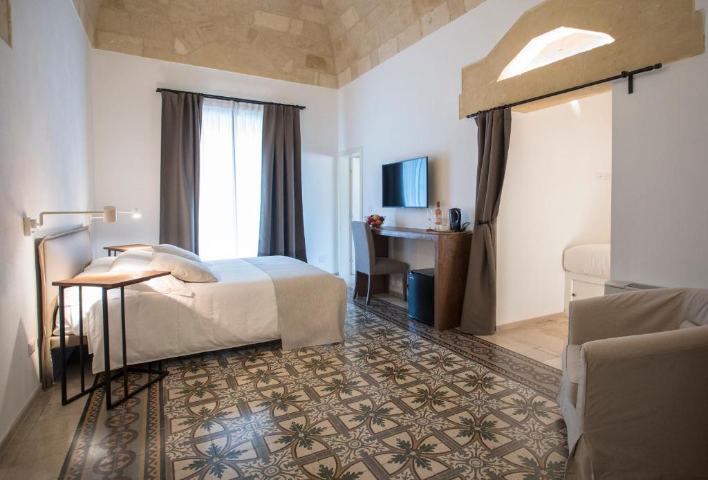 a hotel room with a bed and a desk at Palazzo Montemurro in Matera
