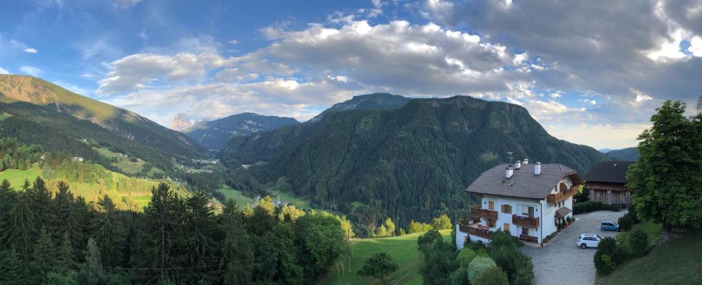 a house in the middle of a valley with mountains at Nature Residence Telfnerhof in Laion