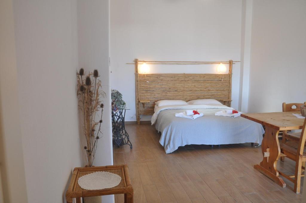a bedroom with a bed and a desk and a table at Apartments Scopello Inside in Scopello