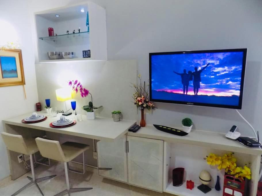 a desk with a tv on top of it at Charmoso Apartamento Leme/copacabana in Rio de Janeiro