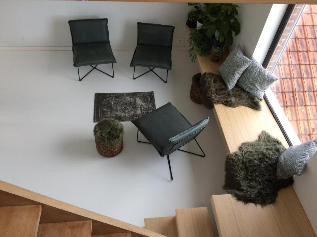 an overhead view of a living room with chairs and a staircase at Nelly in Ypres