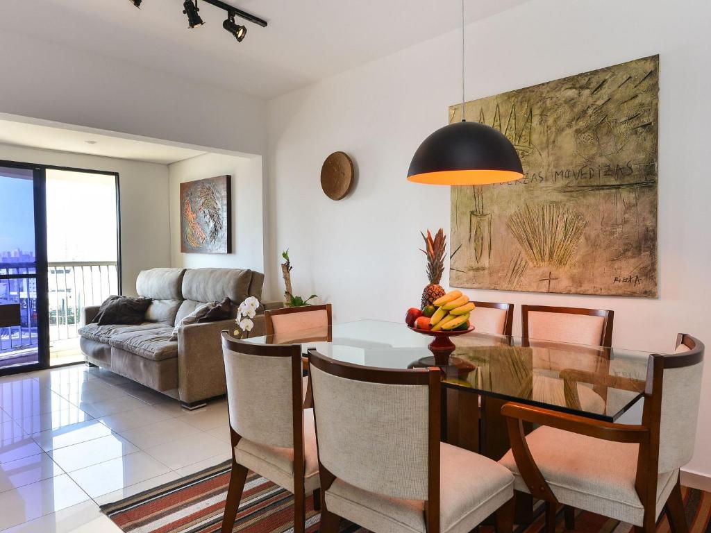 a living room with a table and a couch at Apartamento Aconchegante com Vista Incrível, Piscina e Vaga in São Paulo