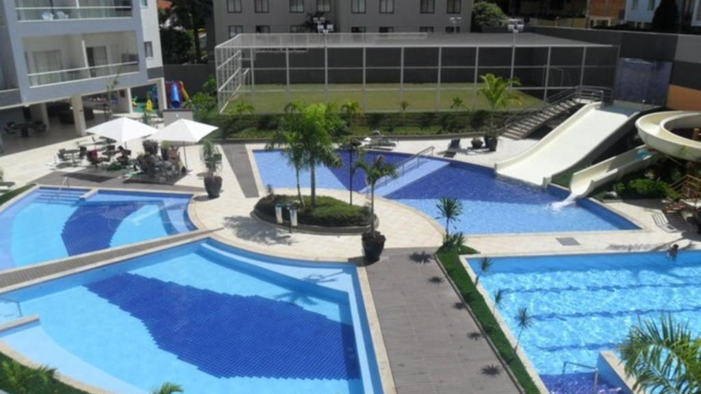 an overhead view of two swimming pools in a building at Flat209 Veredas Rio Quente Particular in Rio Quente
