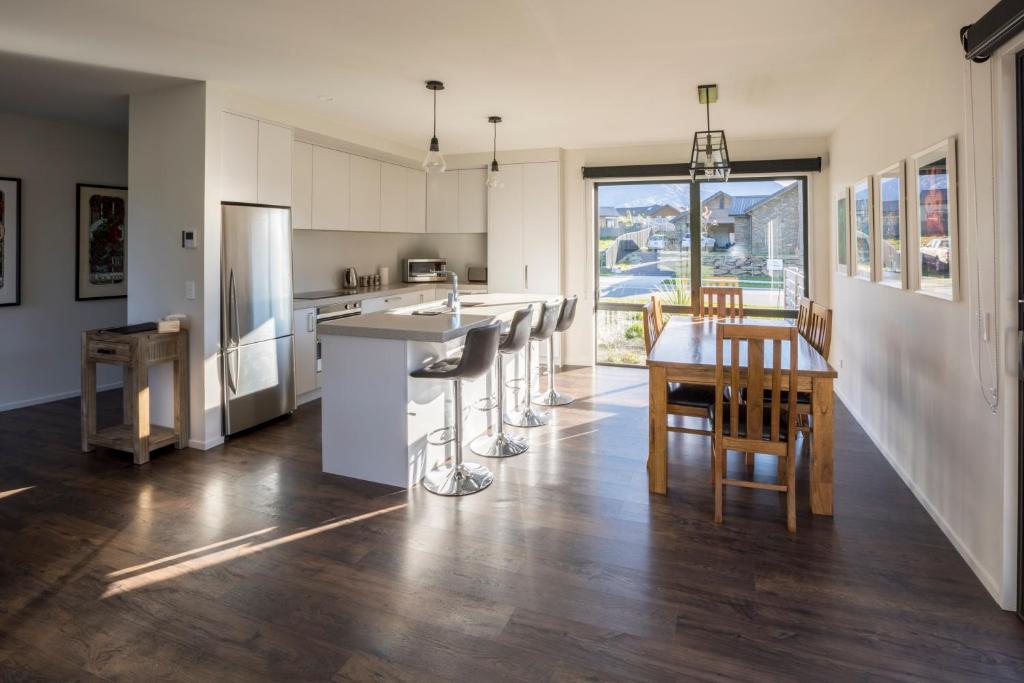 a kitchen with a counter and a table and chairs at Retreat for all seasons in Wanaka