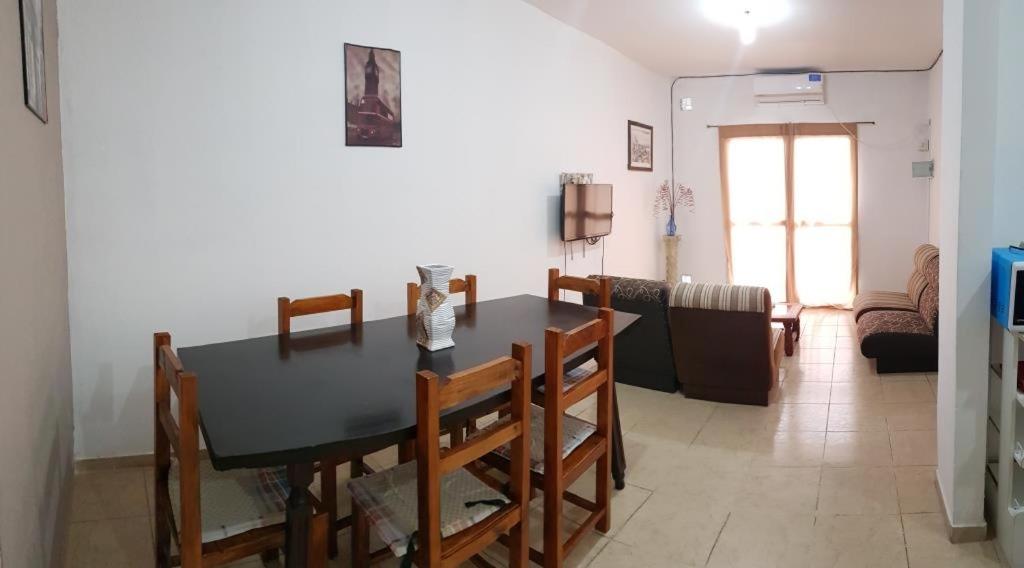 a dining room and living room with a table and chairs at Parador Balcarce in Salta