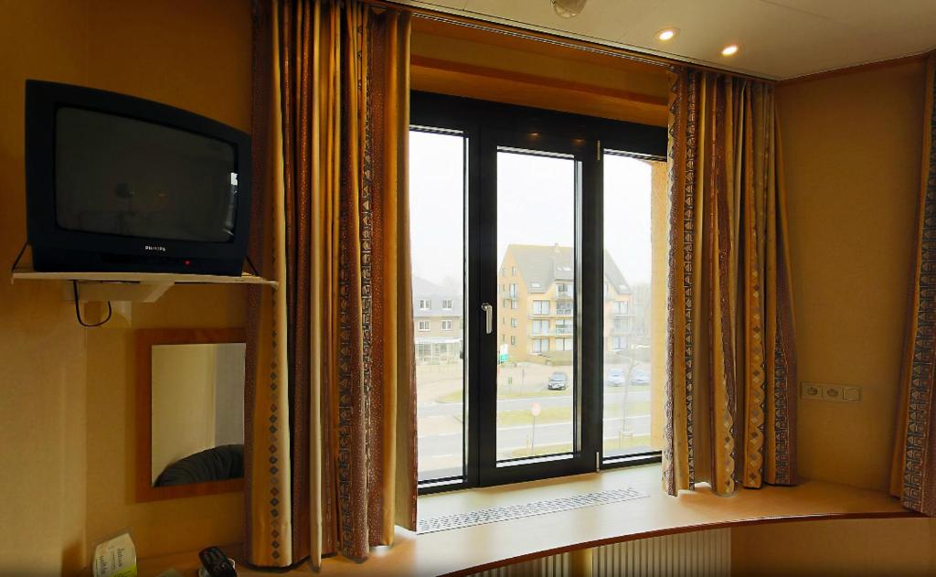 TV a/nebo společenská místnost v ubytování Familiehotel Soll Cress Koksijde