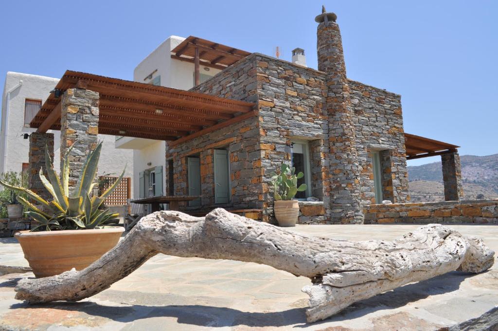a stone house with a statue in front of it at The Hill Top House in Kea in Ioulis