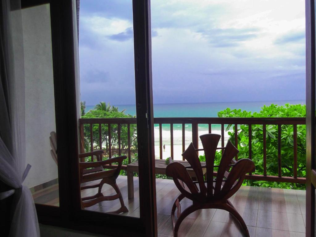 Habitación con balcón con vistas al océano. en Flora and Fauna Mirissa, en Mirissa