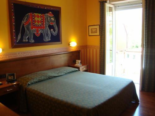 Postel nebo postele na pokoji v ubytování Hotel Verdi