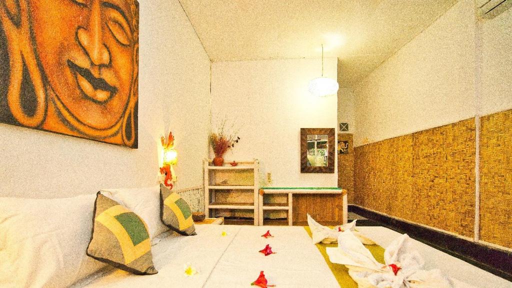 Postel nebo postele na pokoji v ubytování Rumah Kundun