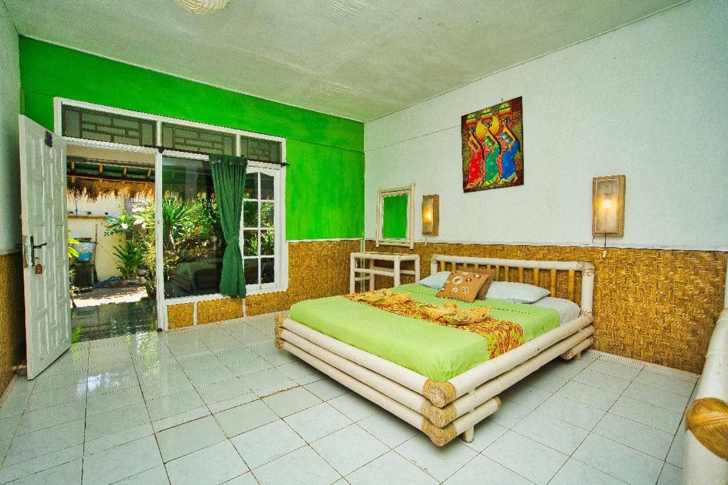 Postel nebo postele na pokoji v ubytování Rumah Kundun