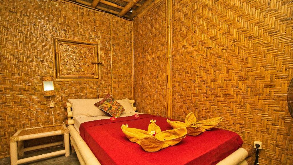 Postel nebo postele na pokoji v ubytování Rumah Kundun