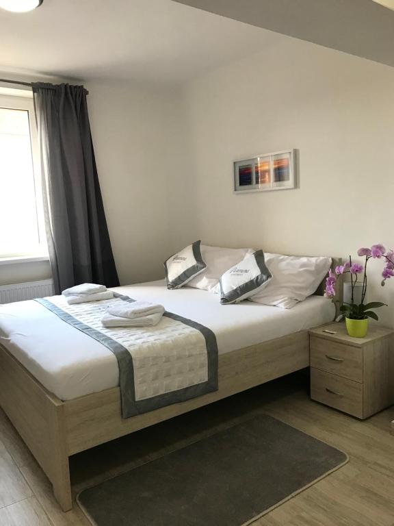 Postel nebo postele na pokoji v ubytování Panorama Apartments