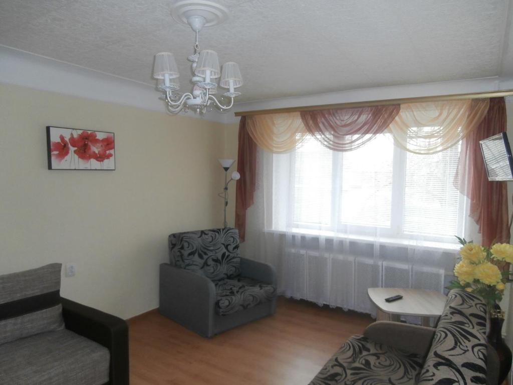 a living room with a chair and a window at Central Daugavpils Apartment in Daugavpils