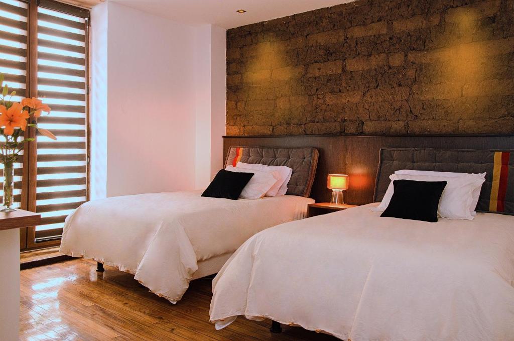 Postel nebo postele na pokoji v ubytování Hotel Casa Gardenia