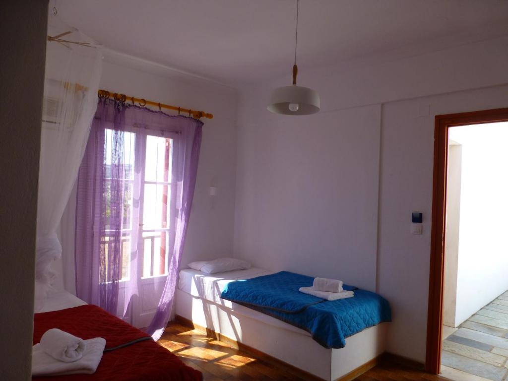 Postel nebo postele na pokoji v ubytování Arokaria Seaside