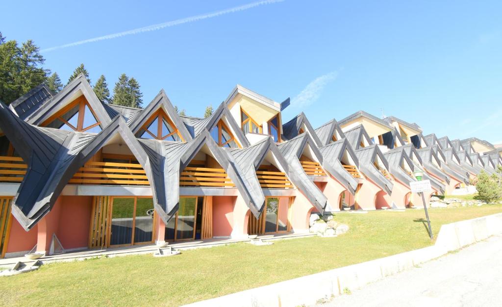 a row of houses with triangular roofs at Ville Golf & Ski in Madonna di Campiglio