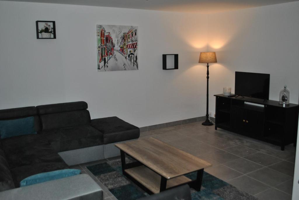 a living room with a couch and a coffee table at appartements T2 ou T3 idéalements situés in Brech