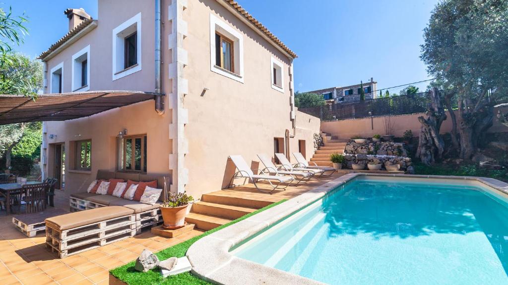 a swimming pool in front of a house at Son Vent in Valldemossa