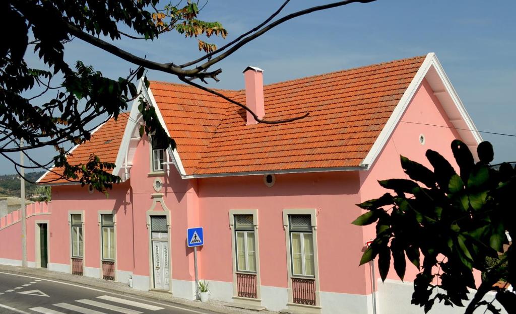 サンタレンにあるChalet Santa Iriaのオレンジ色の屋根のピンク色の建物