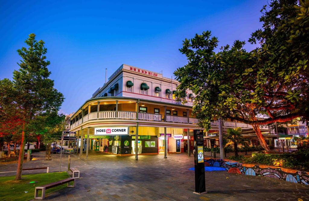 a building on a city street at night at Hides Hotel in Cairns