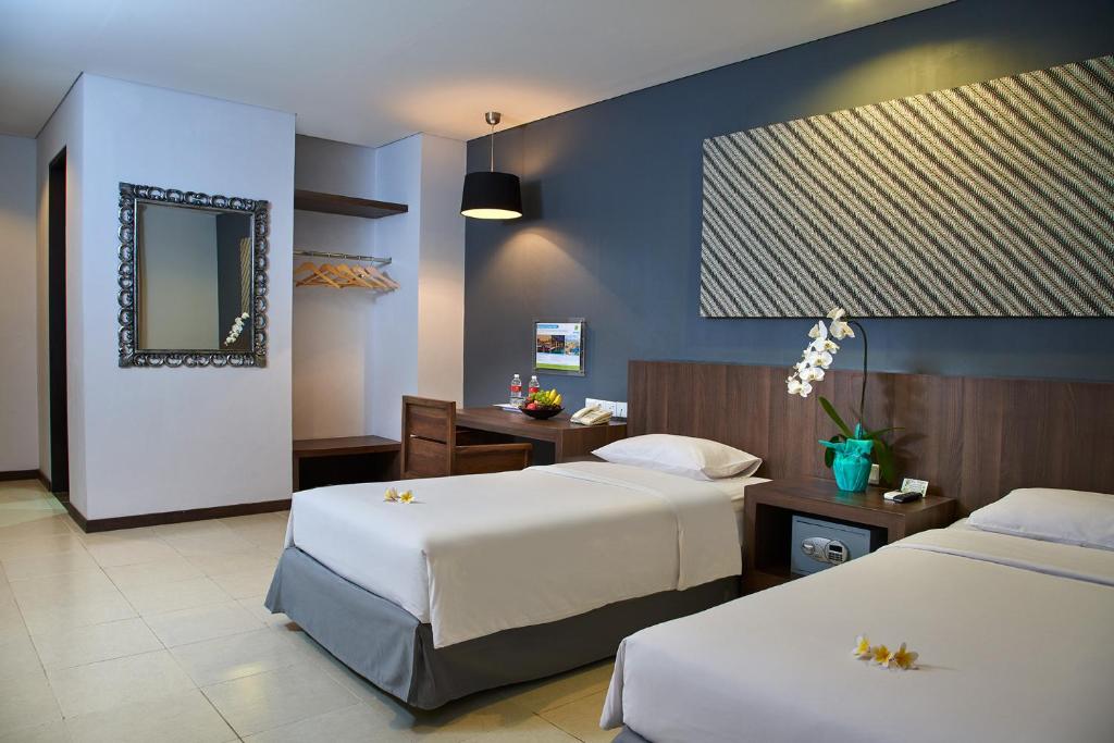 Ένα ή περισσότερα κρεβάτια σε δωμάτιο στο Praja Hotel