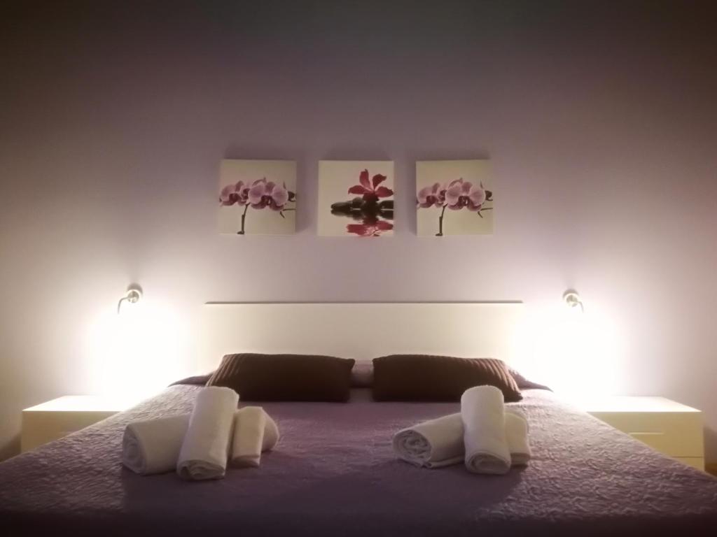 una camera da letto con un letto con due asciugamani bianchi di Appartamento Lorenzo Noto a Noto