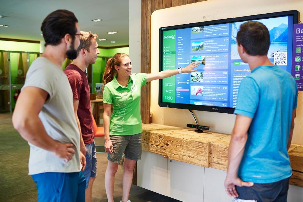 a group of people standing in front of a tv at Explorer Hotel Montafon in Gaschurn