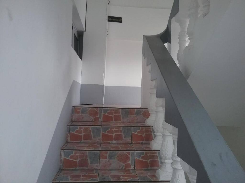 a stairway with a brick wall and a stair case at La Plaine Verte Guesthouse in Port Louis