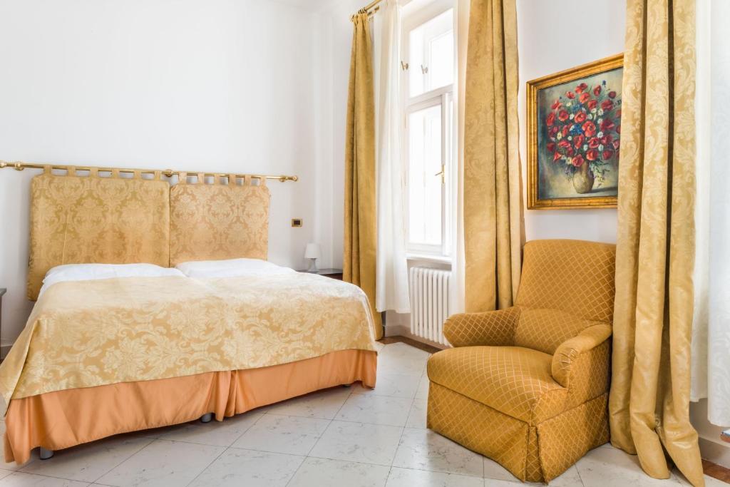Łóżko lub łóżka w pokoju w obiekcie La Fenice