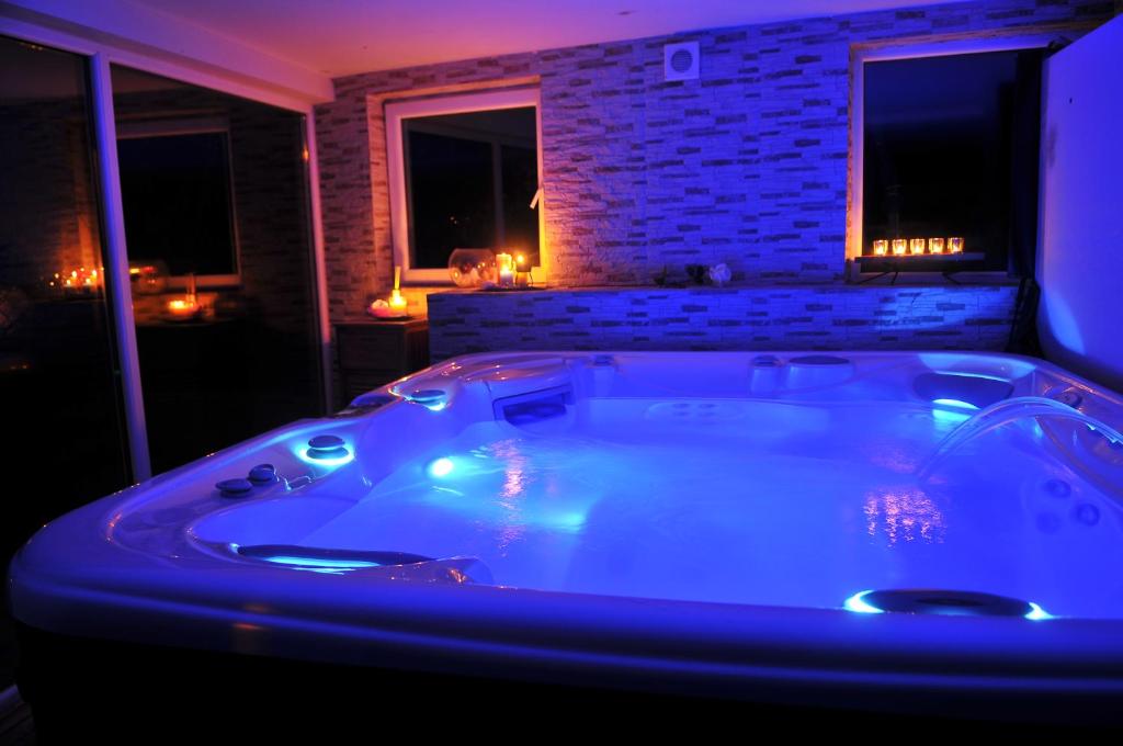 a large bath tub in a room at night at Sweet Secret in Samobor