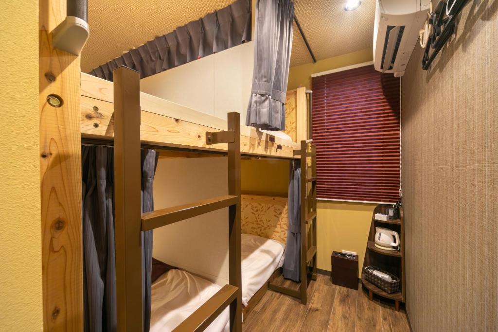 Postel nebo postele na pokoji v ubytování IKIDANE Cozy Hotel Haneda Airport