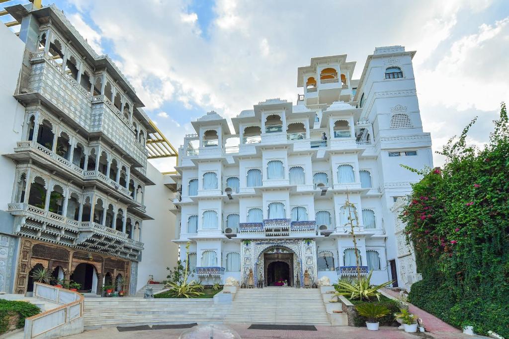 a white building with stairs in front of it at Udai Kothi in Udaipur