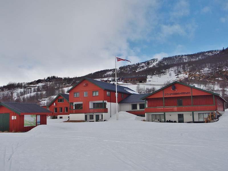 a group of red buildings in the snow at Vats Fjellstue in Al