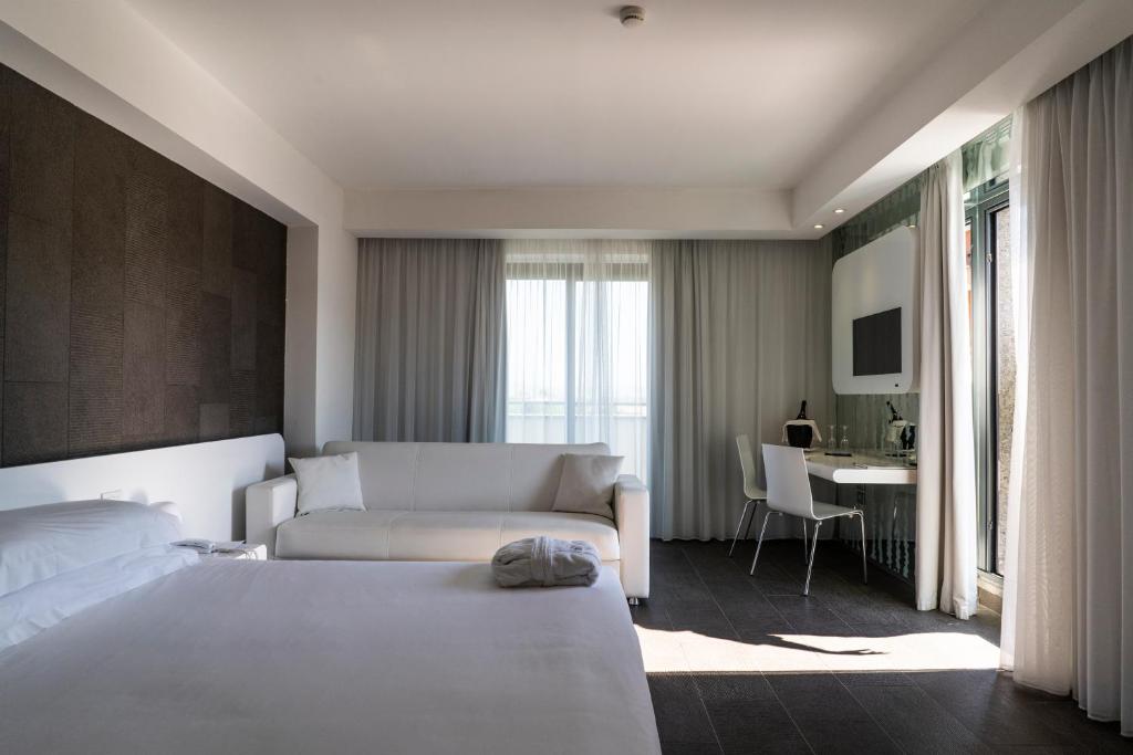 Postel nebo postele na pokoji v ubytování A Point Porto Ercole Resort & Spa