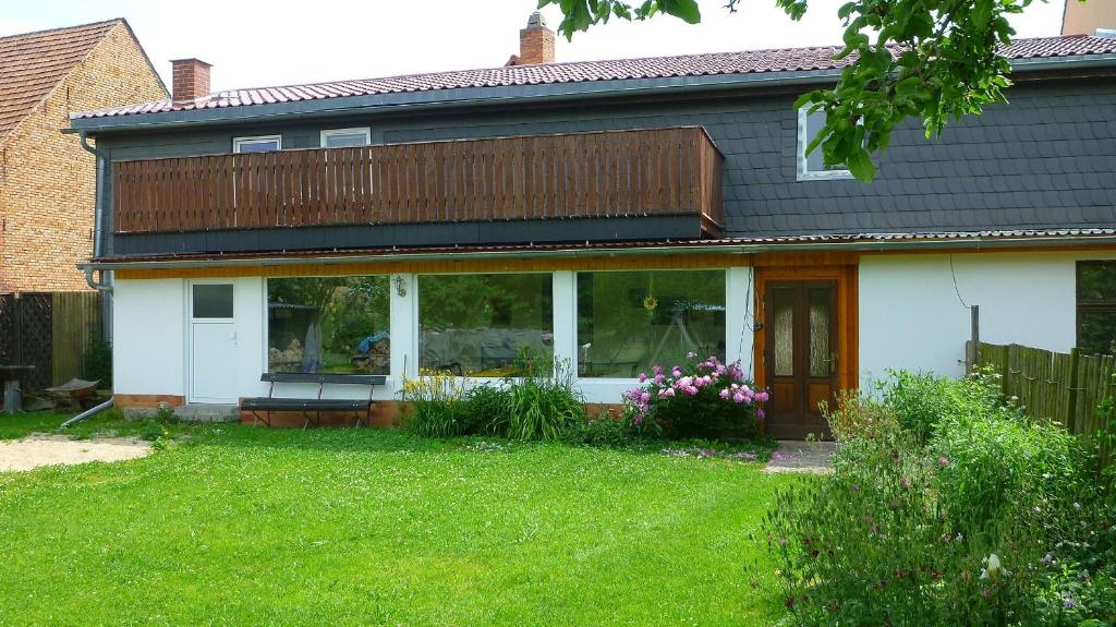 a house with a deck on top of it at Ferienwohnung Meier in Gumperda