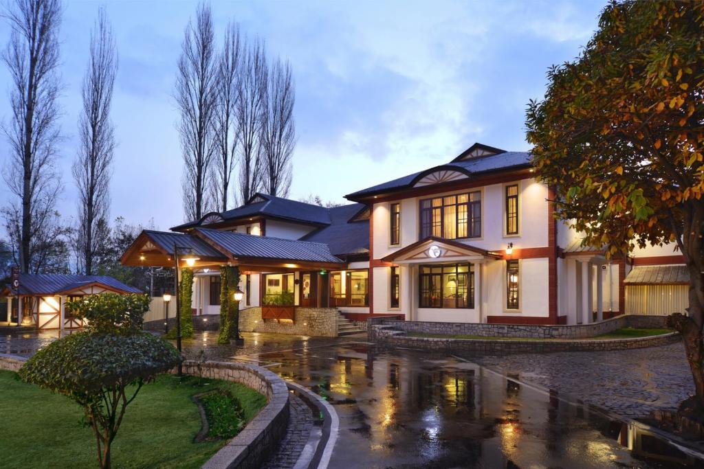 a house in the rain with its lights on at Fortune Resort Heevan, Srinagar - Member ITC's Hotel Group in Srinagar