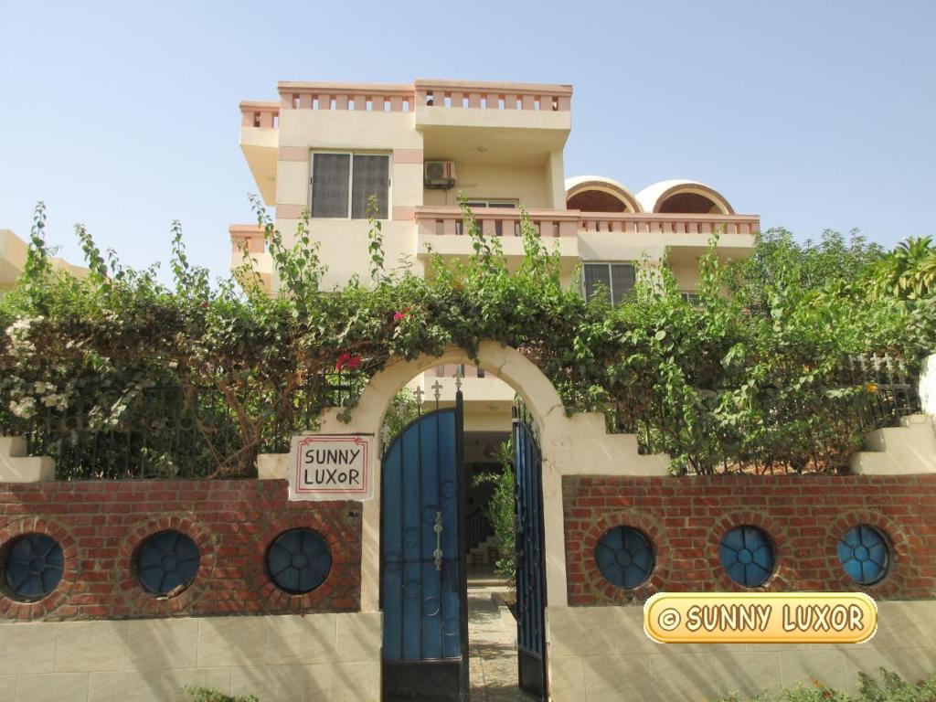 a house with an archway in front of a building at Sunny Luxor in Luxor