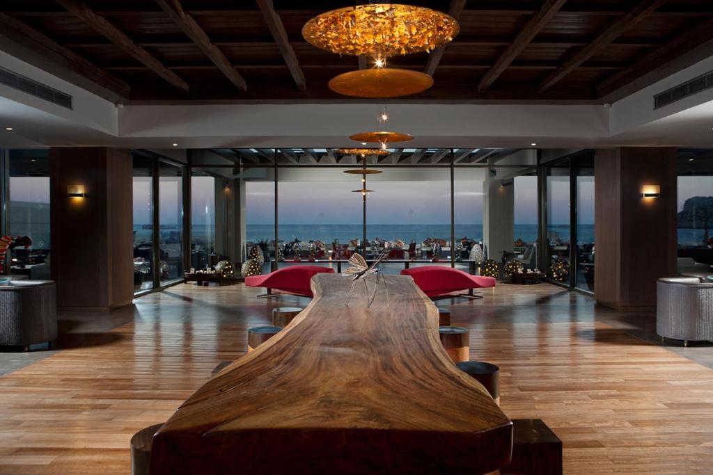 a large wooden table in a lobby with a view at Aquagrand Exclusive Deluxe Resort Lindos - Adults only in Lindos