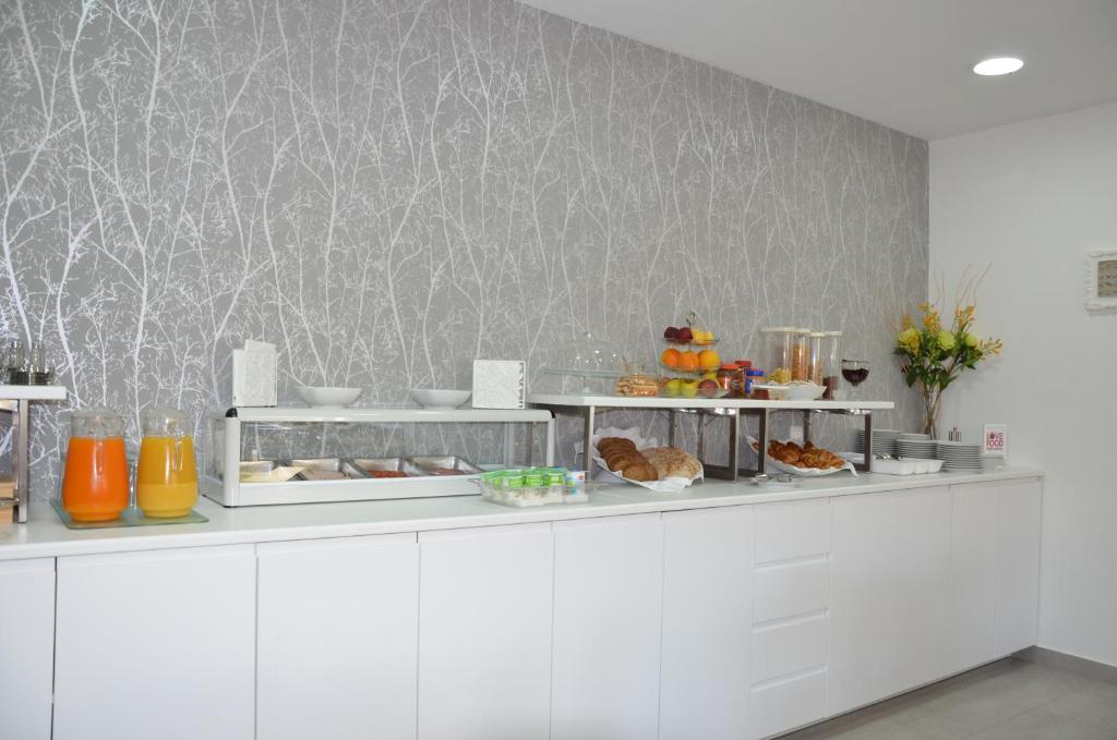 a kitchen with a counter with food on it at ABLA Guest House in Carcavelos