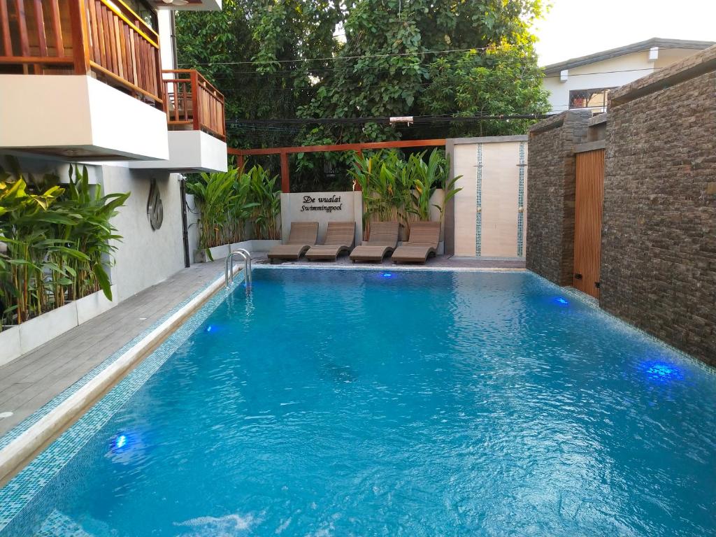 a swimming pool in the middle of a building at Hotel De Wualai-SHA Extra Plus in Chiang Mai