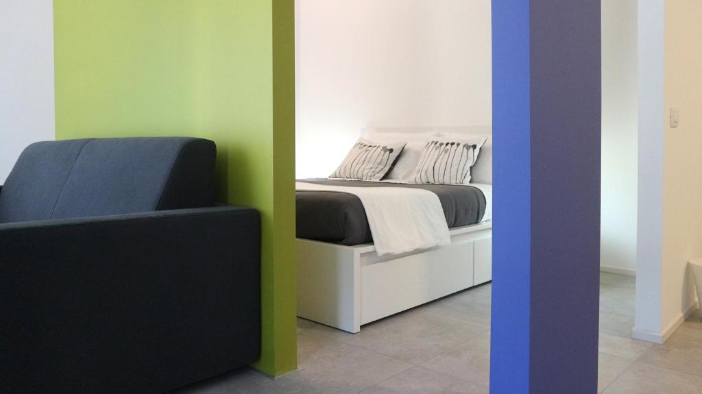 a bedroom with a bed and a colorful wall at C come Colorato in Como