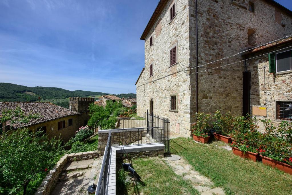 an external view of a stone building with a staircase at Torre nel Chianti in Greve in Chianti
