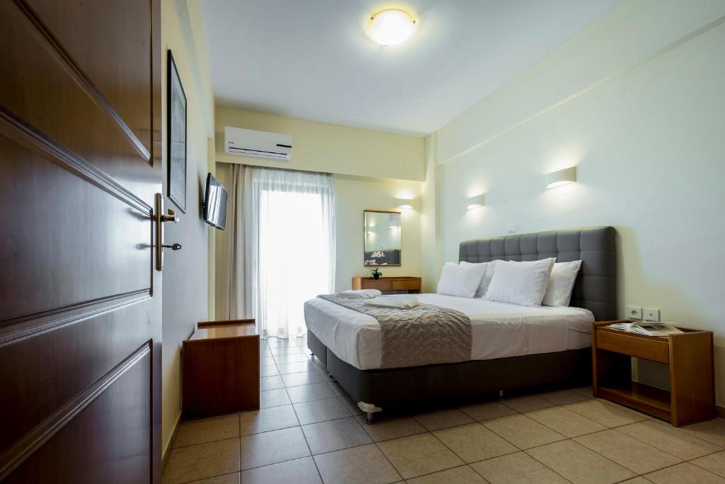 a hotel room with a bed and a window at Gramvoussa Bay in Kissamos